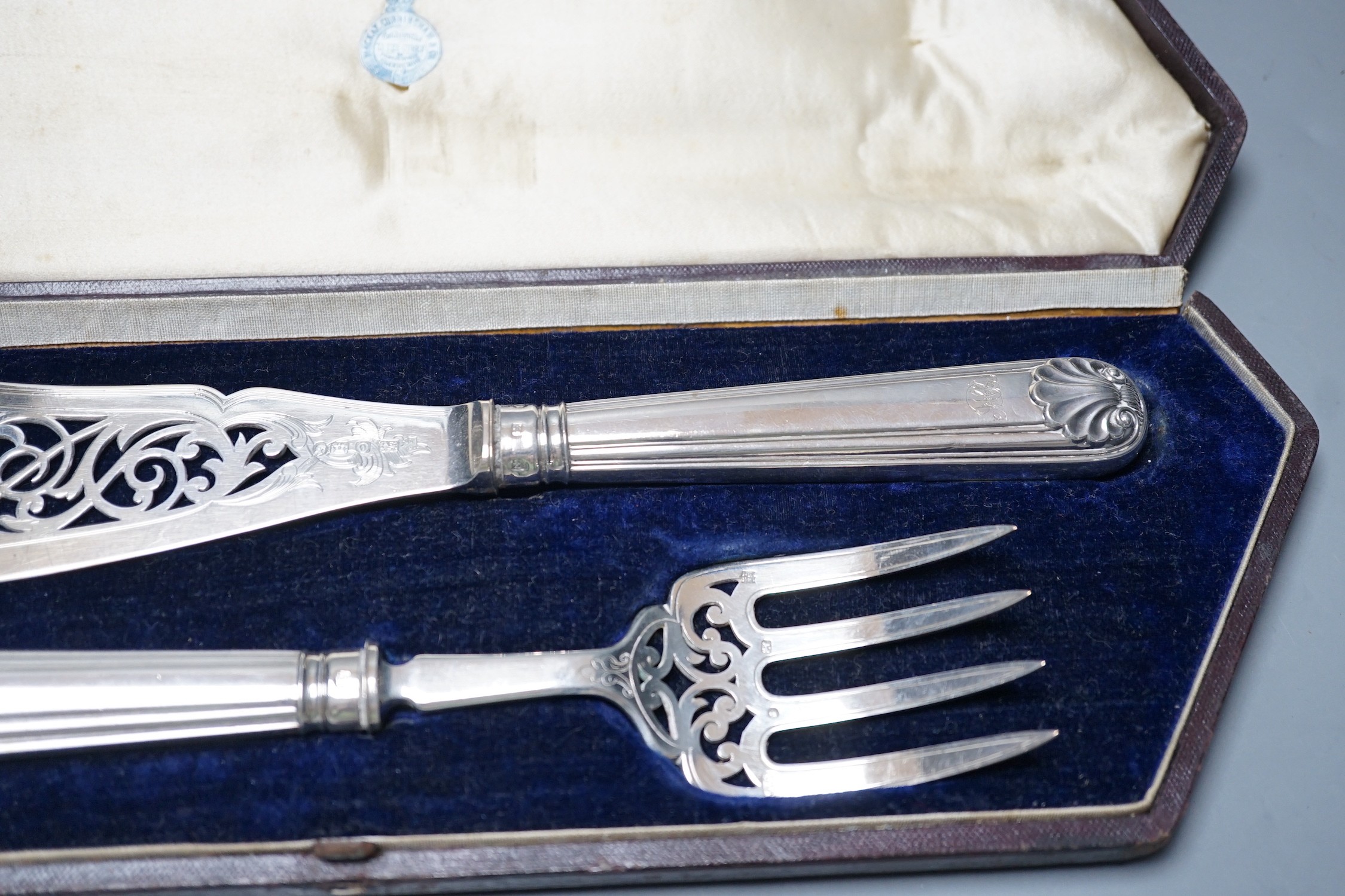 A cased pair of Victorian silver fish servers, Martin, Hall & Co, Sheffield, 1857, knife 31.2, loaded handles.